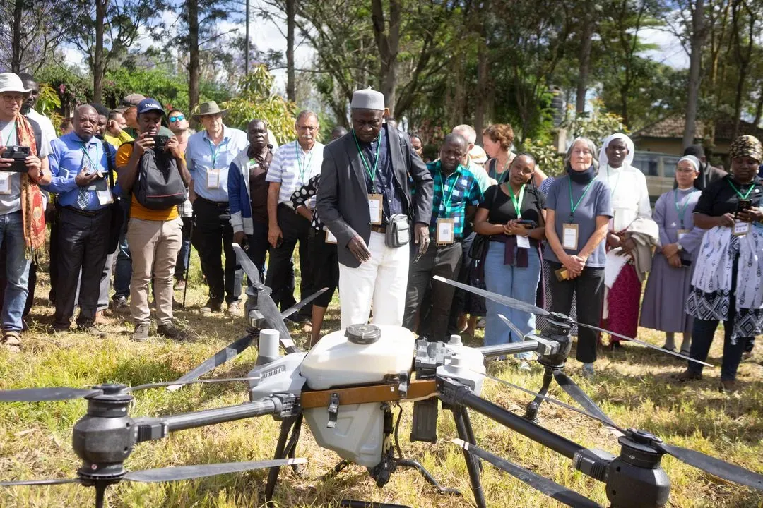 Group of researchers observing a drone spraying Artemisia biopesticide in Arusha, Tanzania